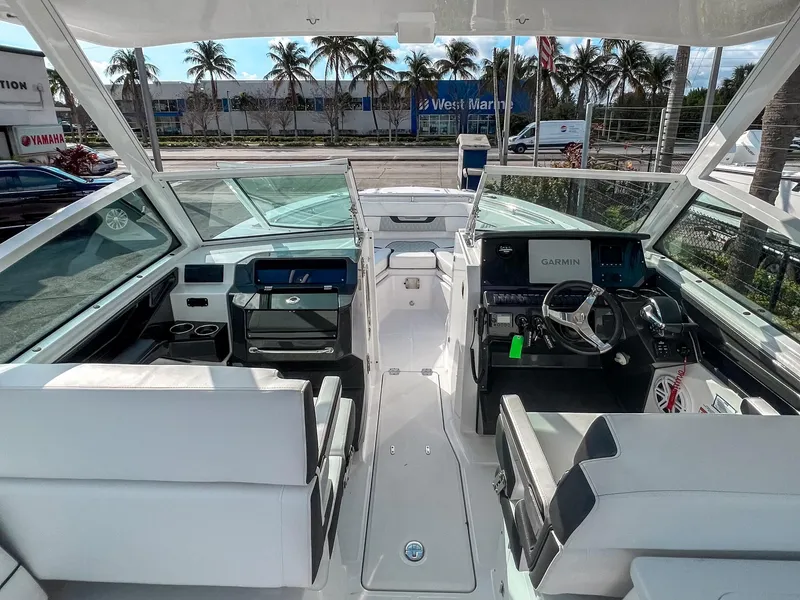 Slide: The Image of 2024 Blackfin 272DC boat interior with modern helm, seating, and Garmin navigation system. - 7