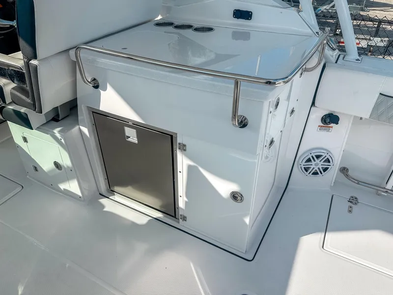 Slide: The Image of 2024 Blackfin 272DC boat interior with storage compartment and seating area. - 15