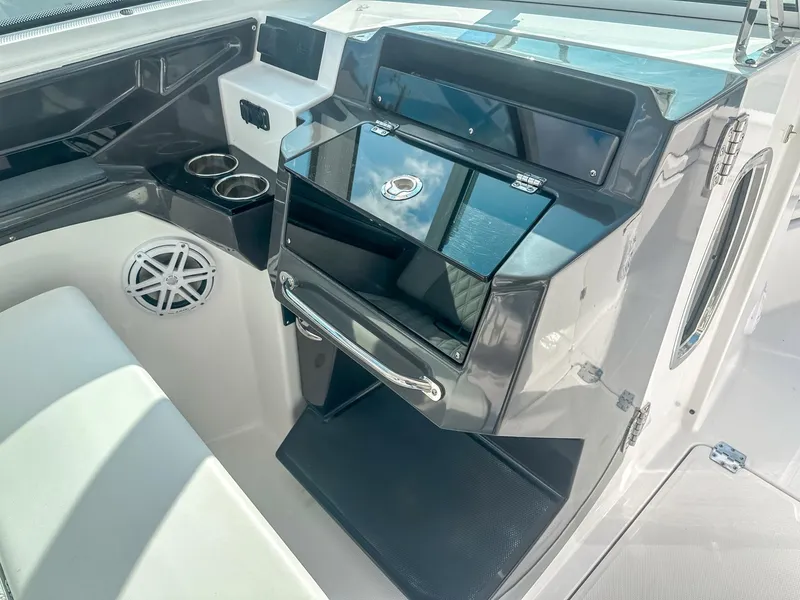 Slide: The Image of 2024 Blackfin 272DC boat interior with sleek dashboard and cup holders. - 17