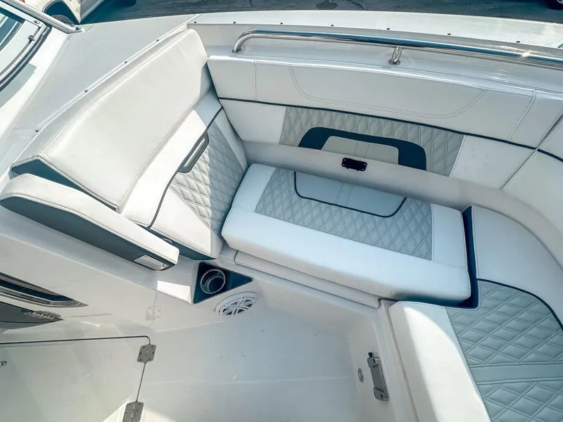 Slide: The Image of 2024 Blackfin 272DC boat interior with luxurious white and gray seating. - 20