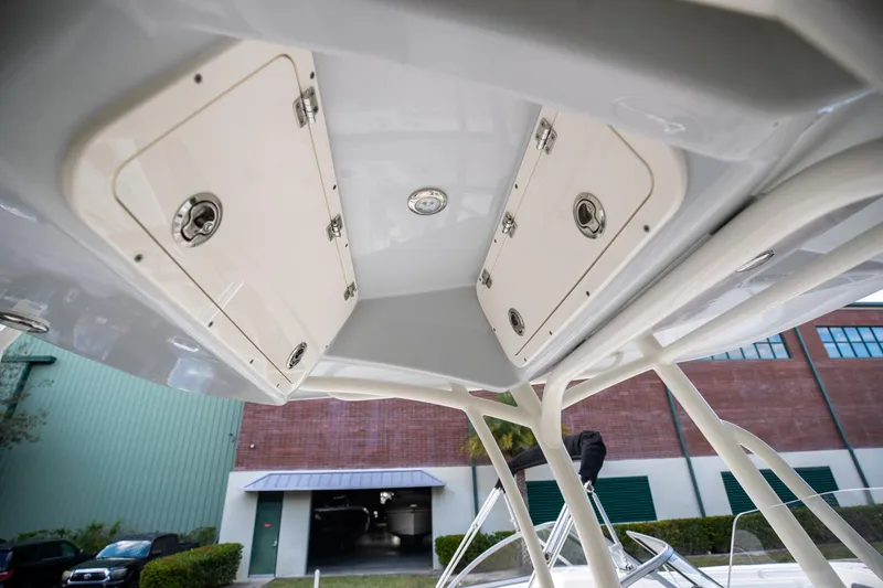 Slide: The Image of 2024 Cobia 220 CC boat's overhead storage compartments and structure. - 20