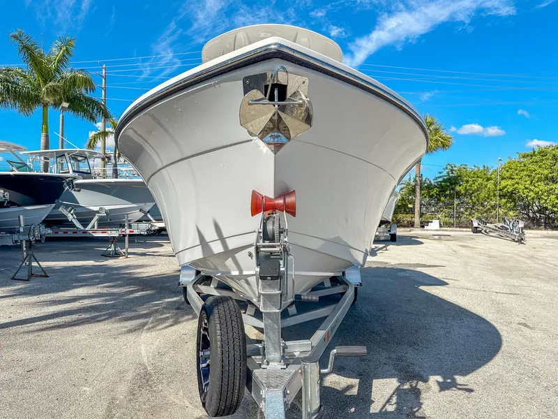 Slide: The Image of 2024 Cobia 220 CC boat on trailer under clear blue sky. - 3
