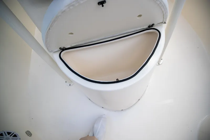 Slide: The Image of Storage compartment on 2024 Cobia 220 CC boat, open lid view. - 25