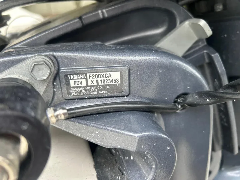 Slide: The Image of Close-up of Yamaha F200XCA engine label on a 2024 Cobia 220 CC boat. - 30