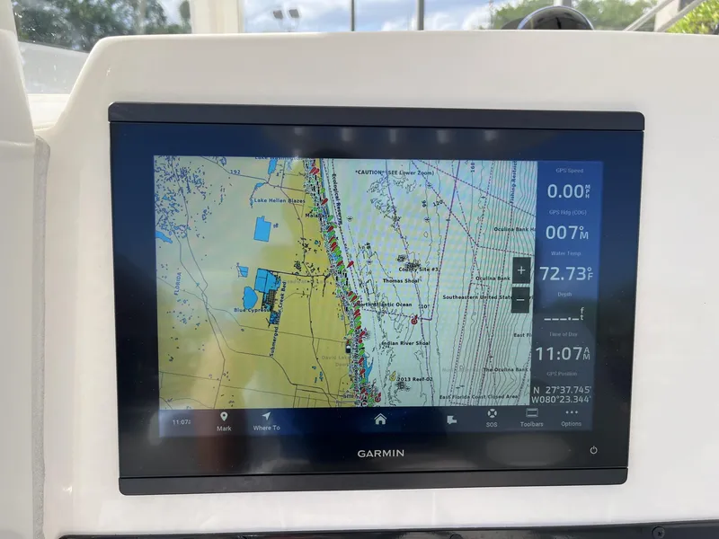 Slide: The Image of Garmin navigation display on 2024 Cobia 262 CC boat, showing detailed marine map. - 12