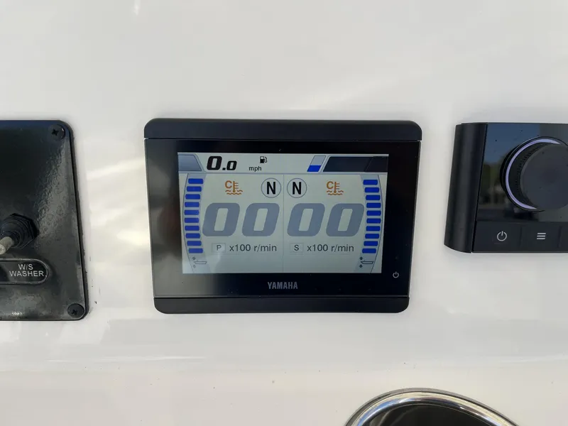 Slide: The Image of Yamaha display on 2024 Cobia 262 CC boat dashboard, showing speed and RPM. - 14