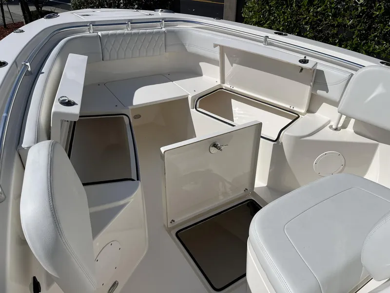 Slide: The Image of 2024 Cobia 262 CC boat interior with open storage compartments and seating. - 17