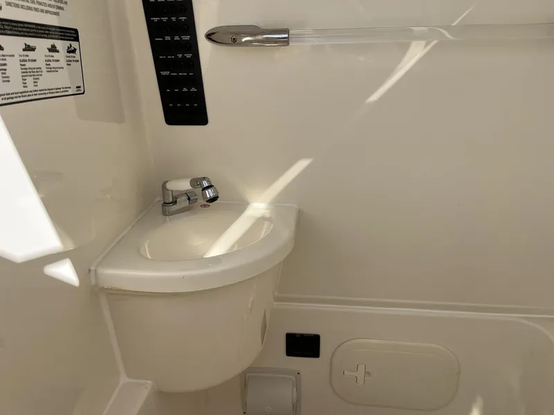 Slide: The Image of 2024 Cobia 262 CC interior sink and control panel detail. - 19