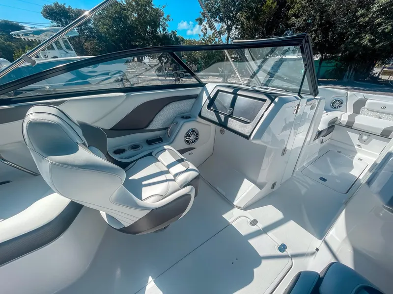 Slide: The Image of 2024 Hurricane SunDeck 2600 OB boat interior with sleek seating and modern dashboard design. - 13