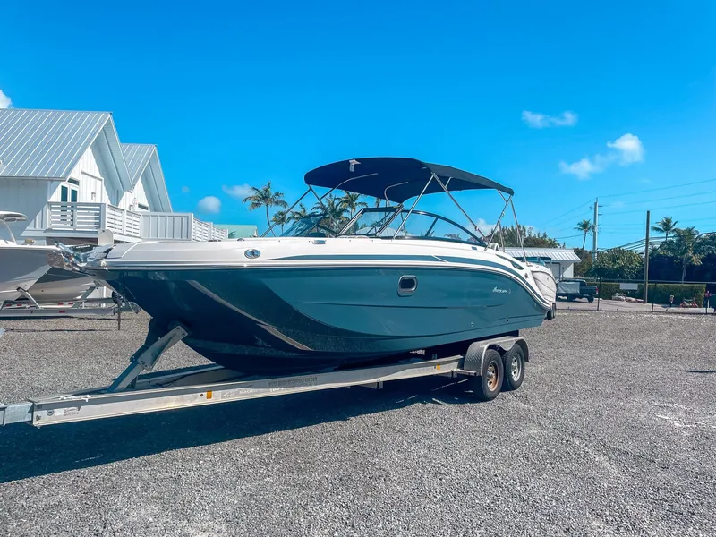 Slide: The Image of 2024 Hurricane SunDeck 2600 OB boat on trailer, sunny day, blue sky background. - 5