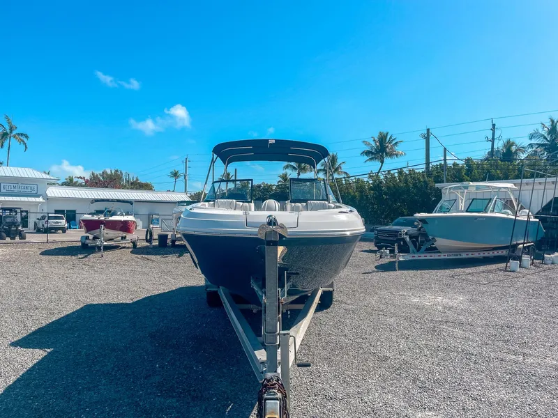 Slide: The Image of 2024 Hurricane SunDeck 2600 OB boat on trailer under clear blue sky. - 6