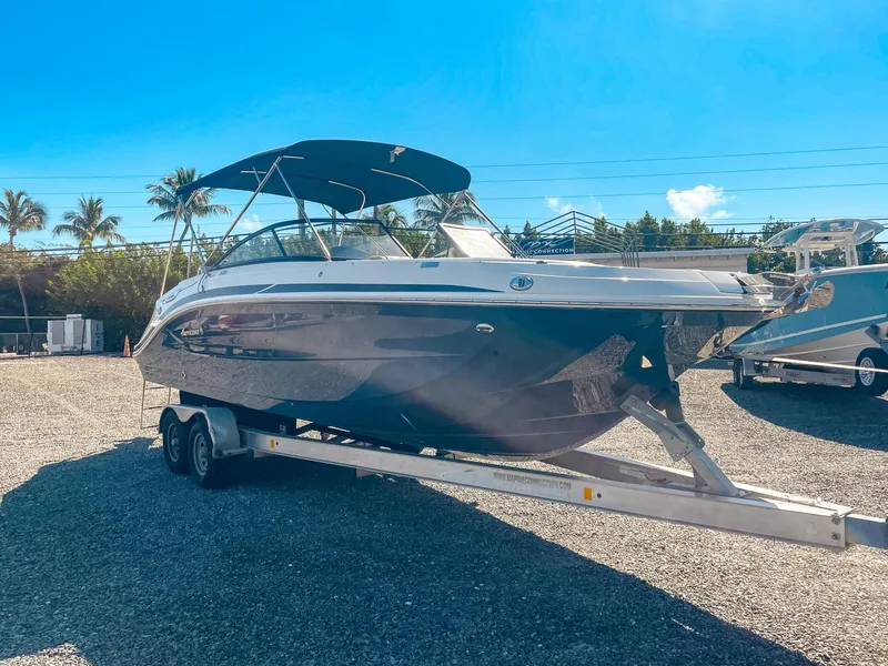 Slide: The Image of 2024 Hurricane SunDeck 2600 OB boat on trailer, sunny outdoor setting. - 7
