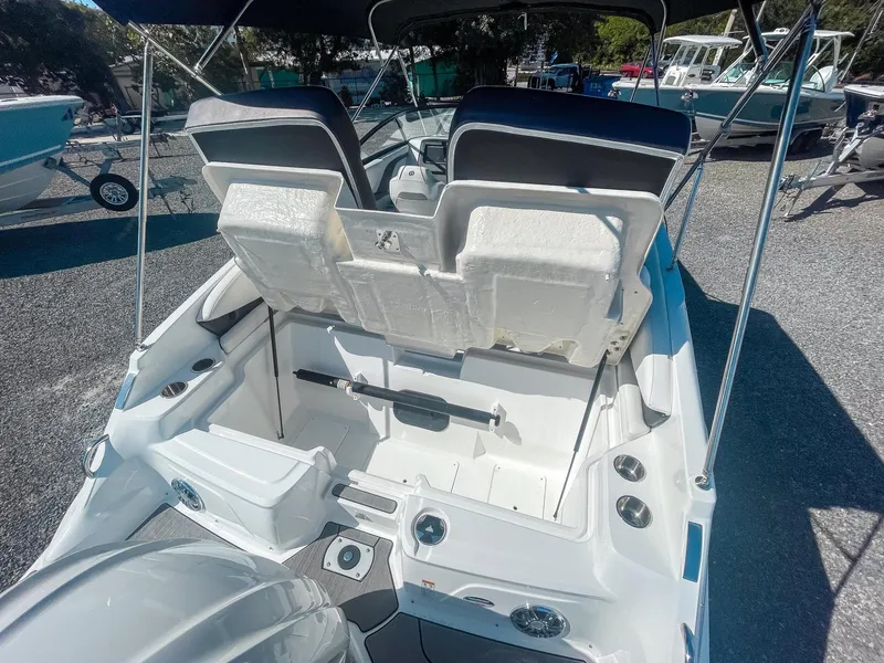 Slide: The Image of 2024 Hurricane SunDeck 2600 OB boat interior with open storage compartment. - 9