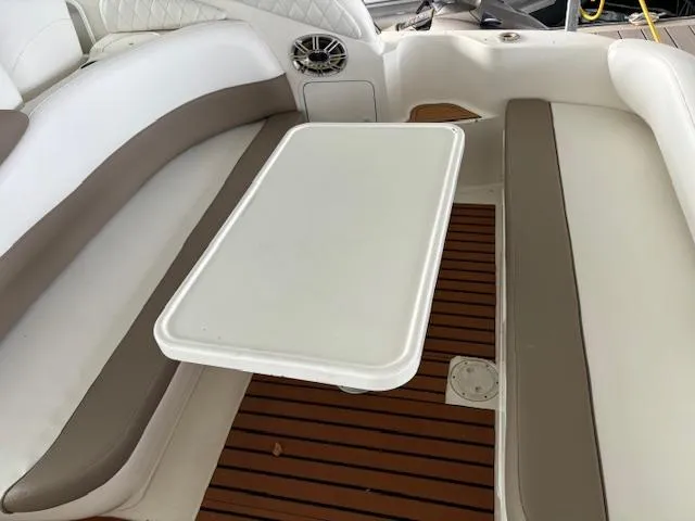Slide: The Image of Interior seating area of a 2000 Sea Ray 340 Sundancer with a white table. - 10