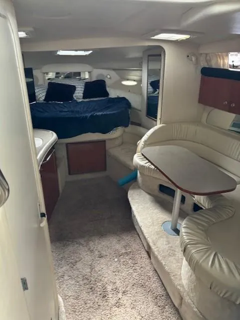 Slide: The Image of Interior of 2000 Sea Ray 340 Sundancer yacht with cozy seating and sleeping area. - 12