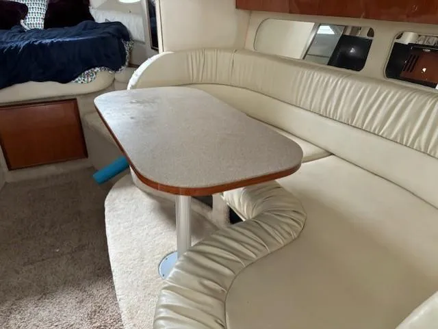 Slide: The Image of Interior of 2000 Sea Ray 340 Sundancer with beige seating and table. - 14