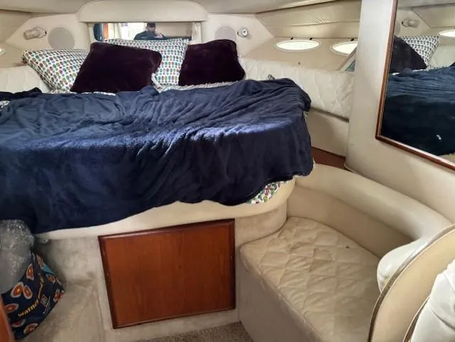 Slide: The Image of Interior cabin of 2000 Sea Ray 340 Sundancer with bed and seating area. - 17