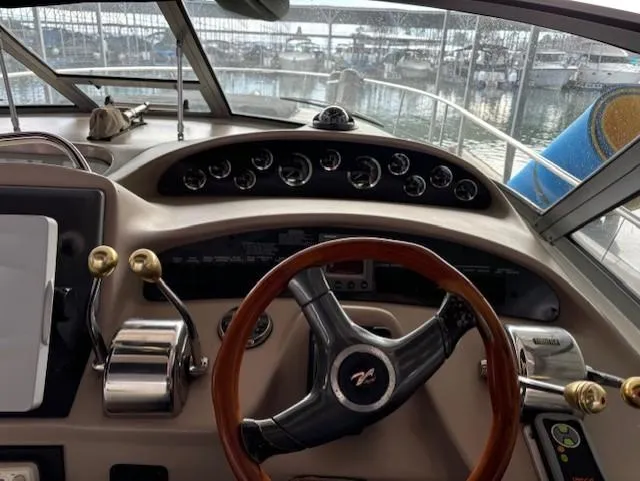 Slide: The Image of Cockpit of 2000 Sea Ray 340 Sundancer with steering wheel and control panel. - 6