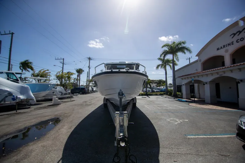 Slide: The Image of 2024 Quarken 35 Cabin boat on trailer in sunny marina setting. - 11