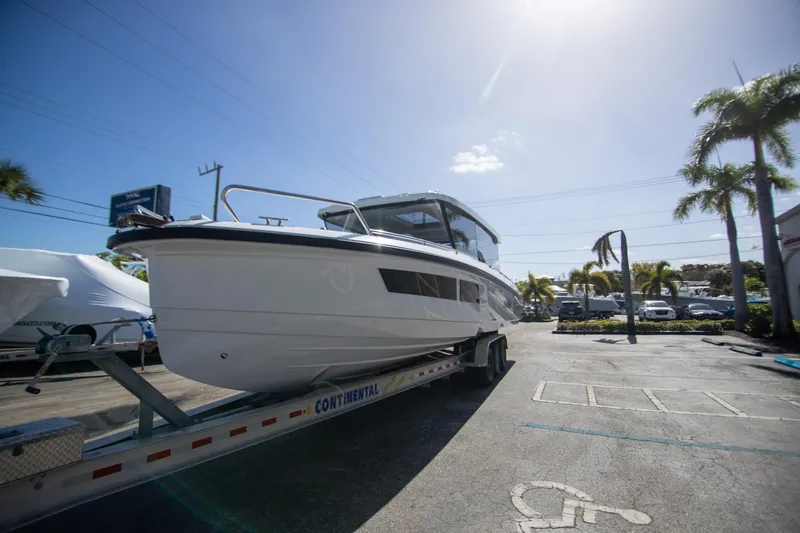 Slide: The Image of 2024 Quarken 35 Cabin boat on trailer in sunny parking lot. - 12