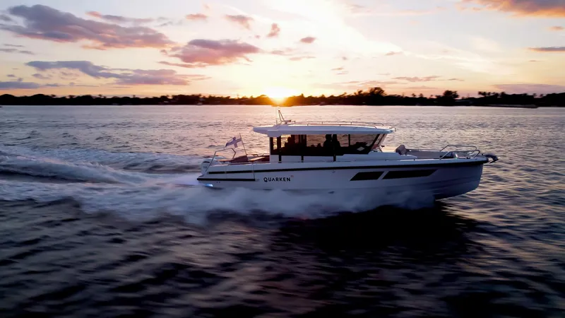 Slide: The Image of 2024 Quarken 35 Cabin boat cruising at sunset on open water. - 2