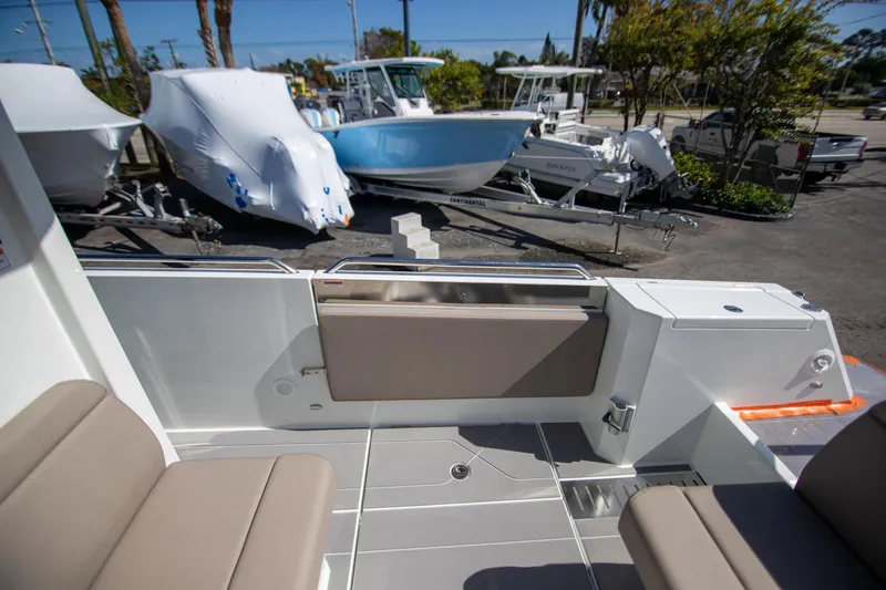 Slide: The Image of 2024 Quarken 35 Cabin interior with seating, docked boats in the background. - 21