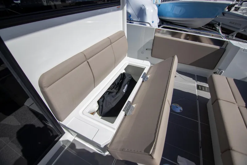 Slide: The Image of 2024 Quarken 35 Cabin boat with open storage compartment under cushioned seating. - 23
