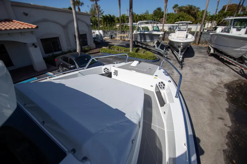 Slide: The Image of 2024 Quarken 35 Cabin boat displayed outdoors with other boats and vehicles nearby. - 26