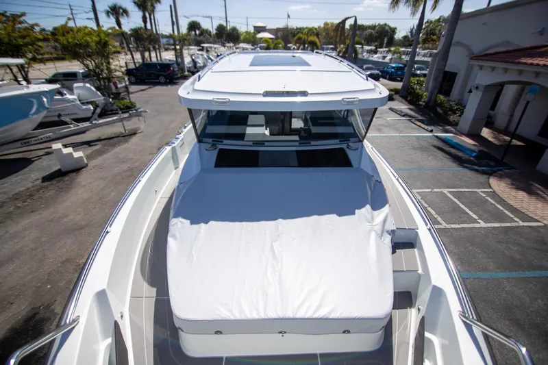 Slide: The Image of 2024 Quarken 35 Cabin boat, docked, showcasing sleek design and spacious deck. - 28