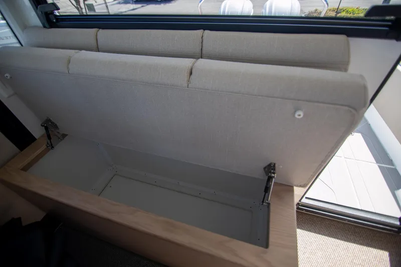 Slide: The Image of 2024 Quarken 35 Cabin interior storage compartment with open cushioned seat. - 35