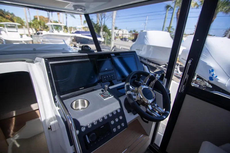 Slide: The Image of 2024 Quarken 35 Cabin boat interior with modern steering console and navigation screens. - 43