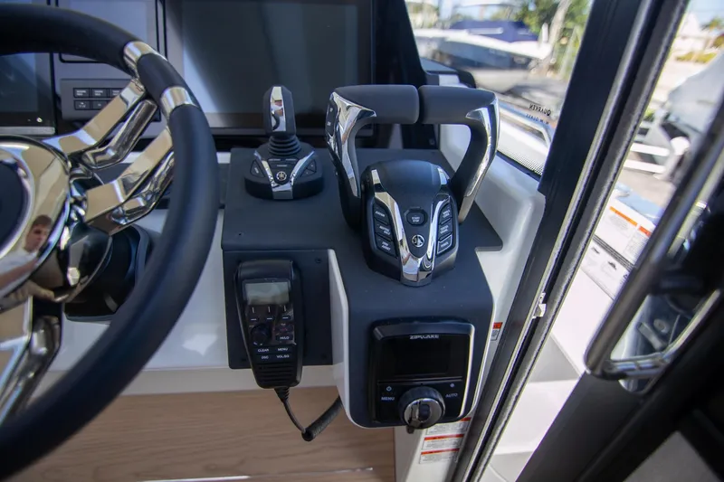 Slide: The Image of Control panel of 2024 Quarken 35 Cabin boat, featuring steering wheel and throttle controls. - 47