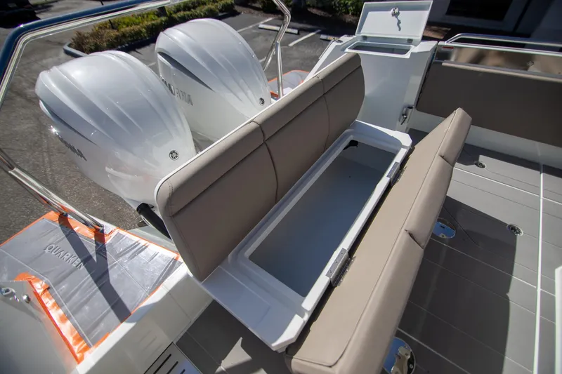 Slide: The Image of 2024 Quarken 35 Cabin boat with open storage compartment and dual outboard engines. - 20