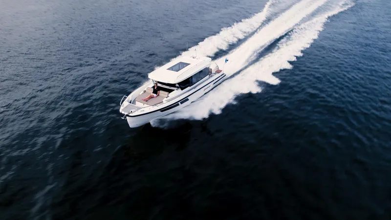 Slide: The Image of 2024 Quarken 35 Cabin cruising on open water, aerial view. - 3