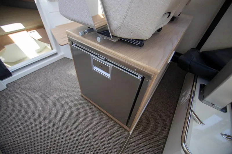 Slide: The Image of 2024 Quarken 35 Cabin interior with compact fridge and seating. - 39