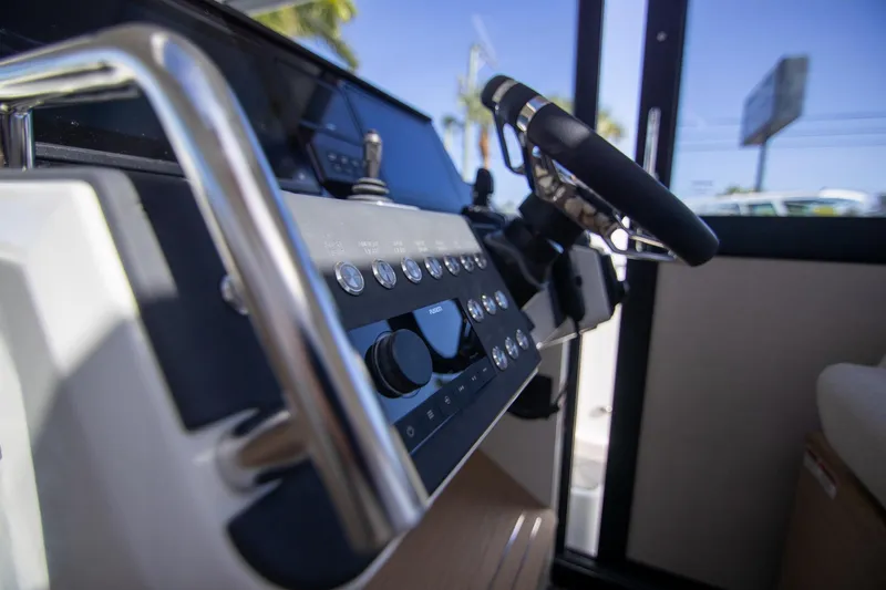 Slide: The Image of Control panel of 2024 Quarken 35 Cabin boat, featuring steering wheel and dashboard controls. - 45