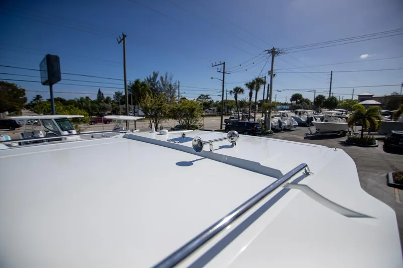 Slide: The Image of 2024 Quarken 35 Cabin boat roof view in a sunny marina setting. - 30