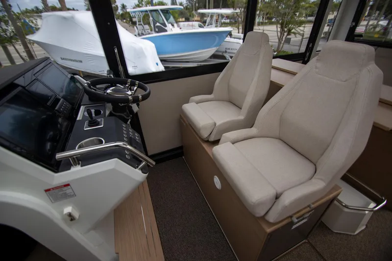 Slide: The Image of Interior of 2024 Quarken 35 Cabin with dual beige seats and modern steering console. - 41