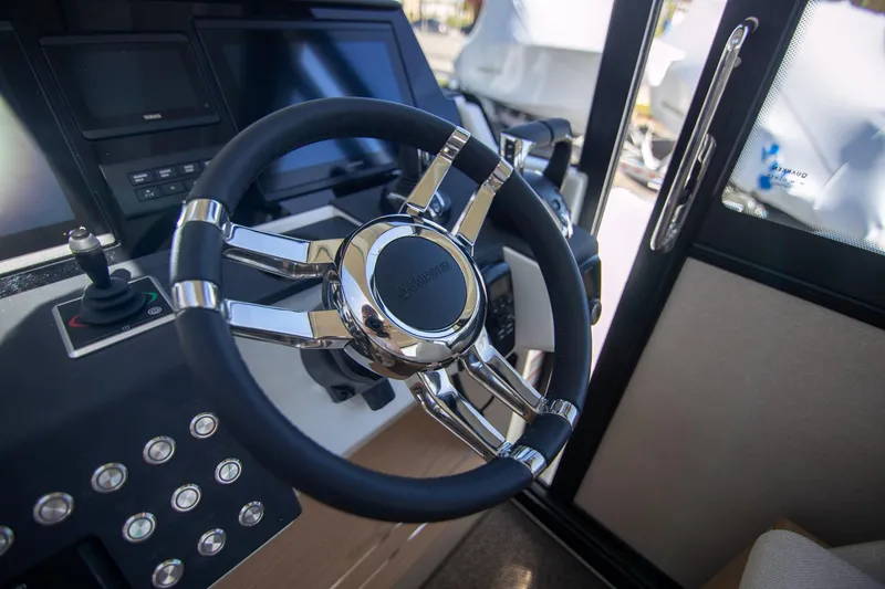Slide: The Image of Steering wheel of 2024 Quarken 35 Cabin boat, featuring modern controls and sleek design. - 44