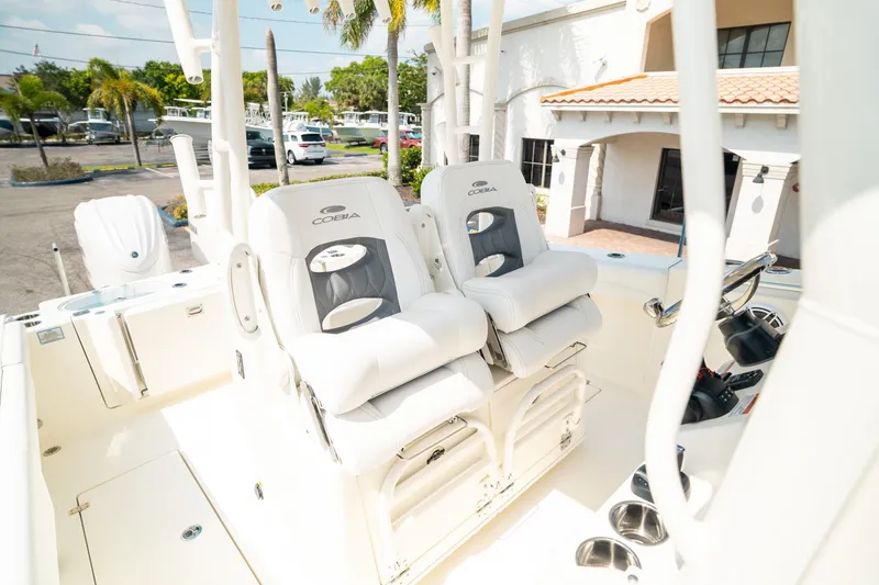 Slide: The Image of 2024 Cobia 301 CC boat interior with plush seating and modern design. - 18