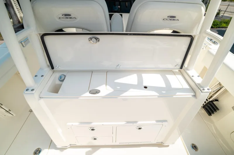 Slide: The Image of 2024 Cobia 301 CC boat interior with storage compartments and seating. - 30
