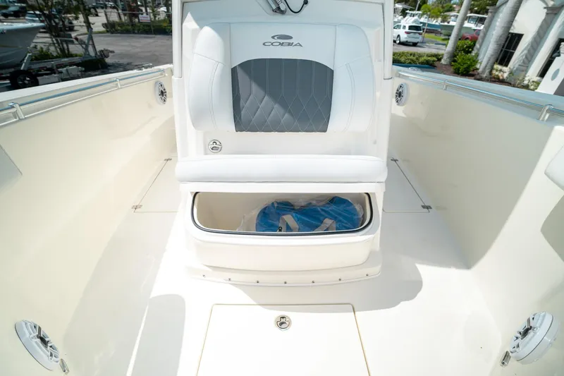 Slide: The Image of 2024 Cobia 301 CC boat interior with storage compartment open. - 48
