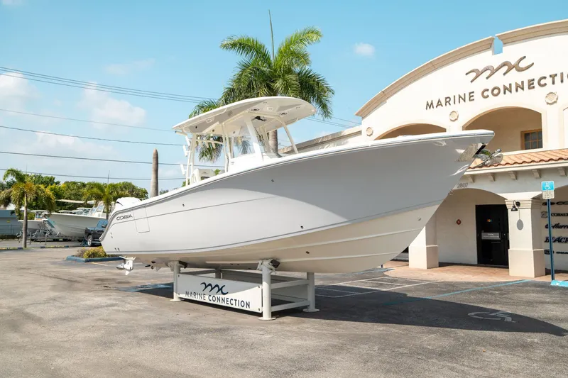 Slide: The Image of 2024 Cobia 301 CC boat displayed at Marine Connection dealership. - 8