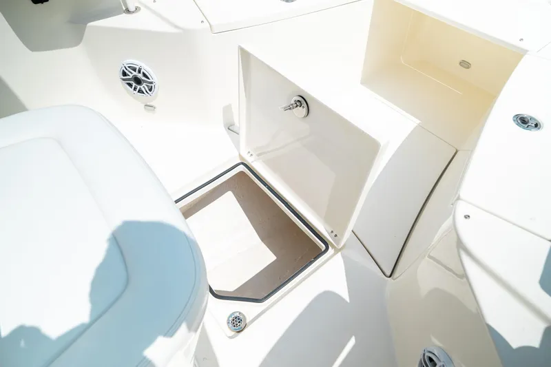 Slide: The Image of 2024 Cobia 301 CC boat interior storage compartment and seating area. - 47
