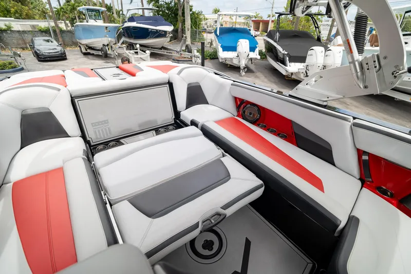 Slide: The Image of 2019 MasterCraft X-Star interior with red and white seating, showcasing luxury and style. - 10