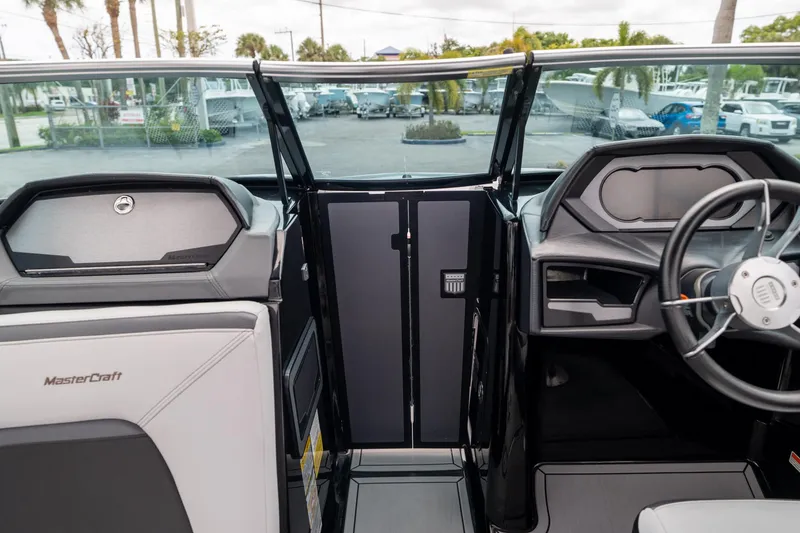 Slide: The Image of 2019 MasterCraft X-Star boat interior with steering wheel and dashboard view. - 13