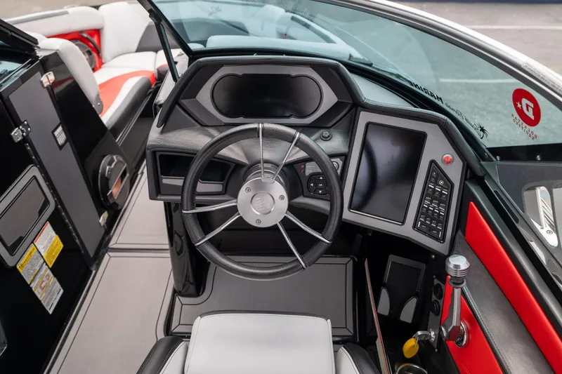 Slide: The Image of 2019 MasterCraft X-Star boat dashboard with steering wheel and control panel. - 15