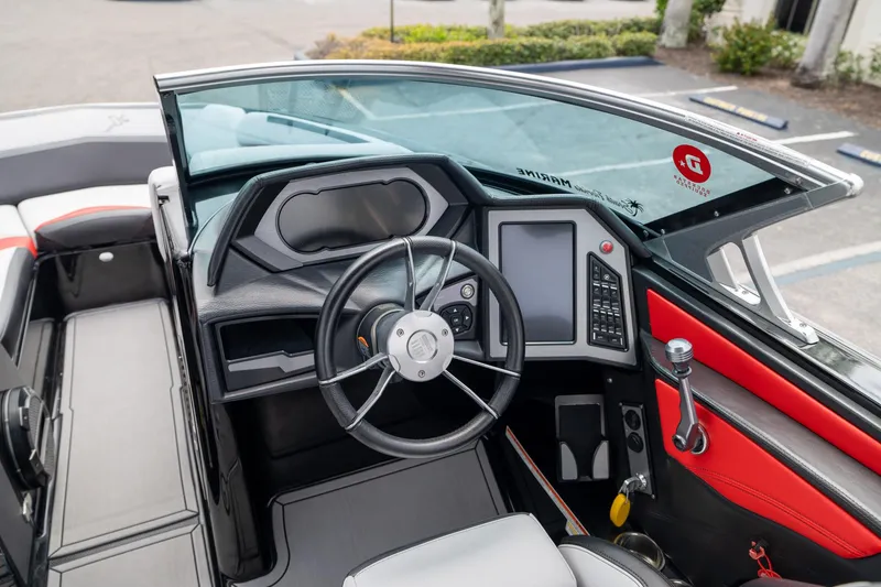 Slide: The Image of 2019 MasterCraft X-Star boat cockpit with modern steering and control panel. - 16