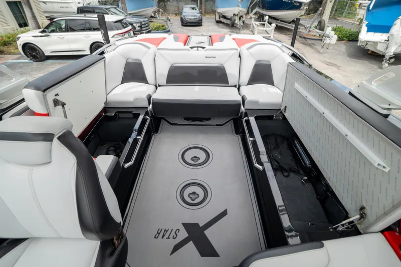 Slide: The Image of 2019 MasterCraft X-Star boat interior with open storage compartments and seating. - 18