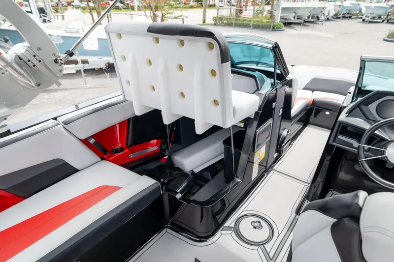 Slide: The Image of 2019 MasterCraft X-Star interior with red and white seating, modern design, and steering wheel. - 19